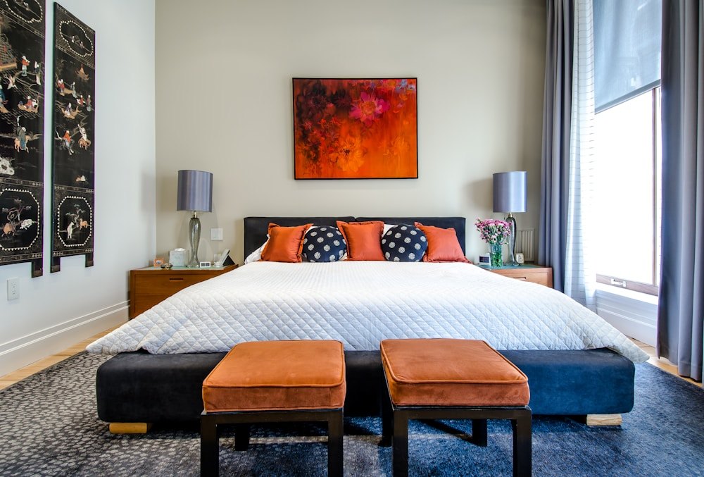 A calm bedroom with natural light and a neatly made bed