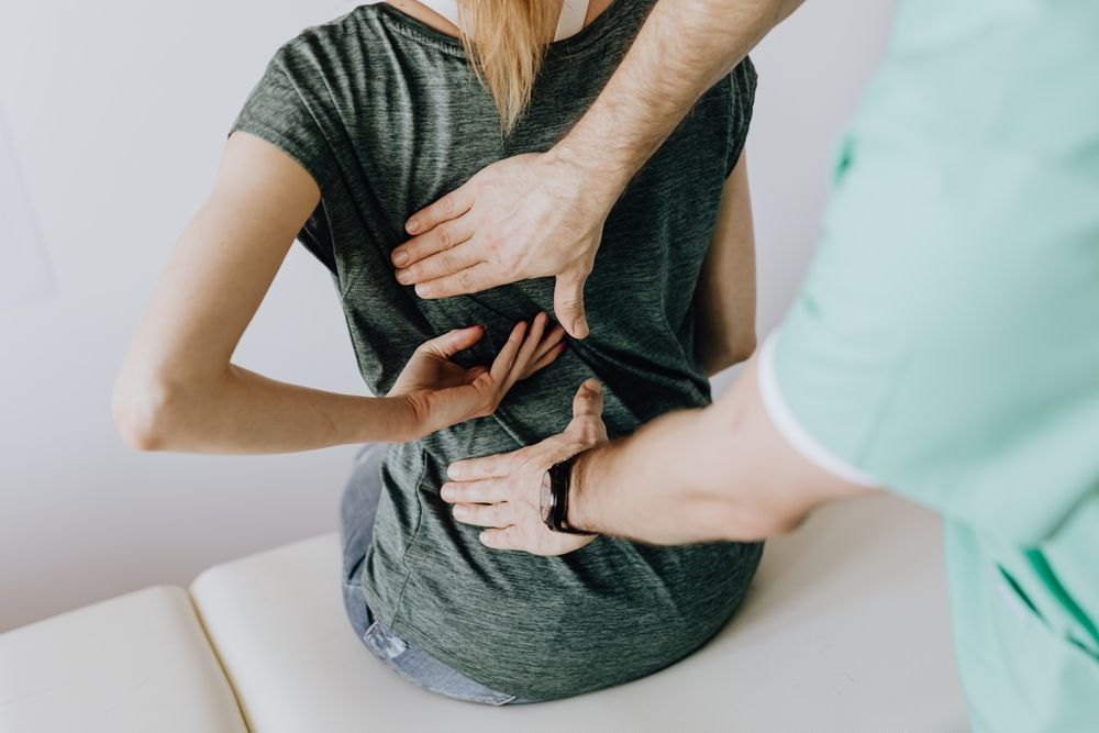 A physical therapist helping a patient with gentle movement