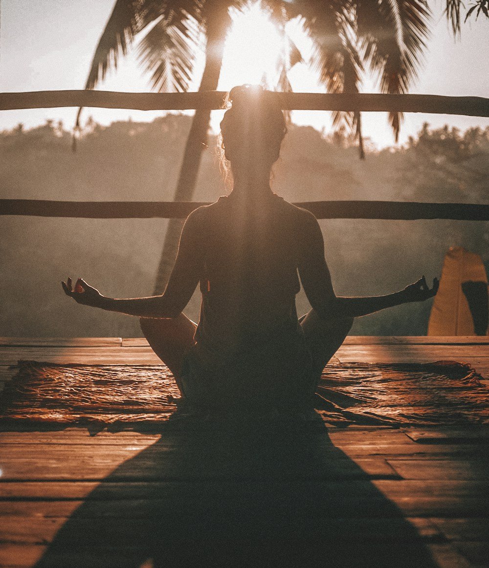 A person taking a quiet moment to meditate in warm sunlight
